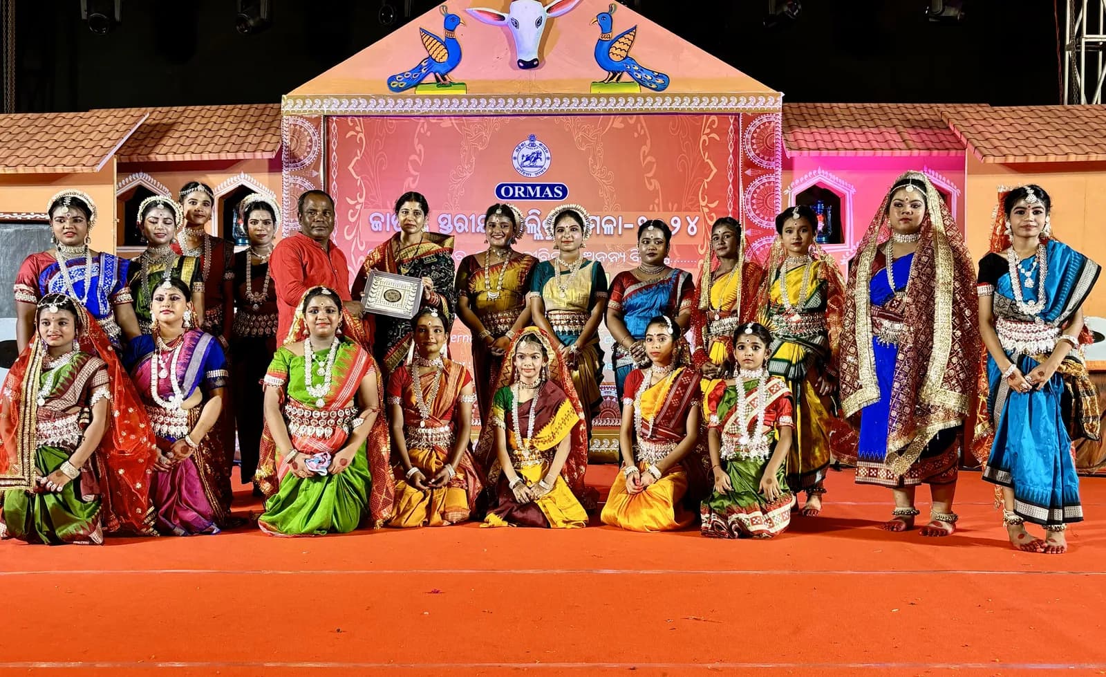 The troupe gathered on stage while a memento is presented