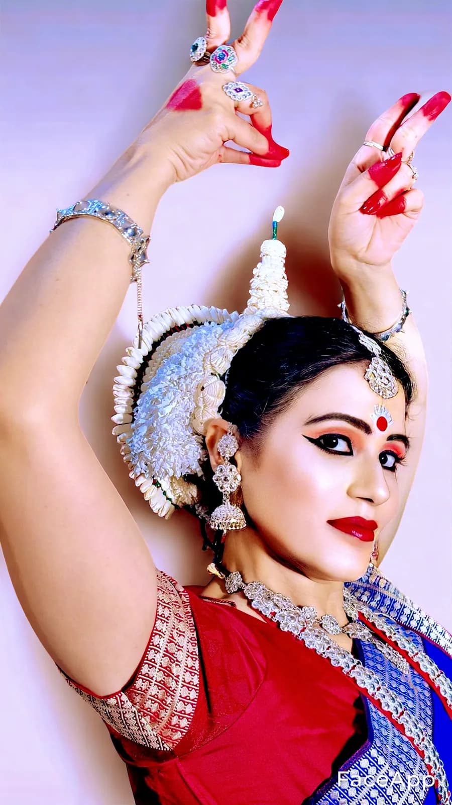 Itishree Pattnaik in full Odissi costume, arms raised above her head