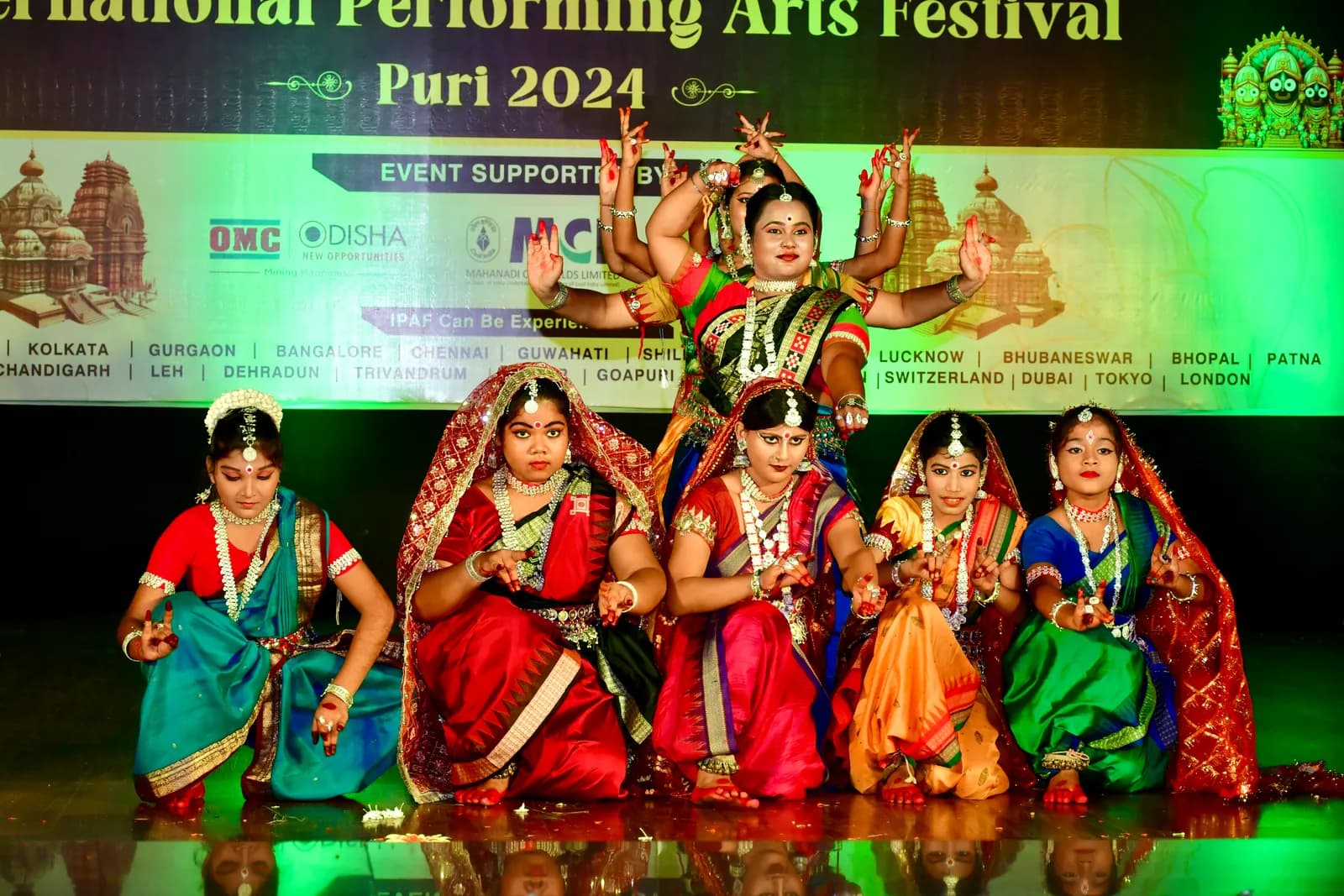 Dancers of Sukumari Kalakendra forming a many-armed Odissi tableau on stage